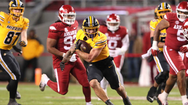 Nov 24, 2023; Fayetteville, Arkansas, USA; Missouri Tigers running back Cody Schrader (7) rushes during the second half against the Arkansas Razorbacks at Donald W. Reynolds Razorback Stadium. Missouri won 48-14. Mandatory Credit: Nelson Chenault-USA TODAY Sports